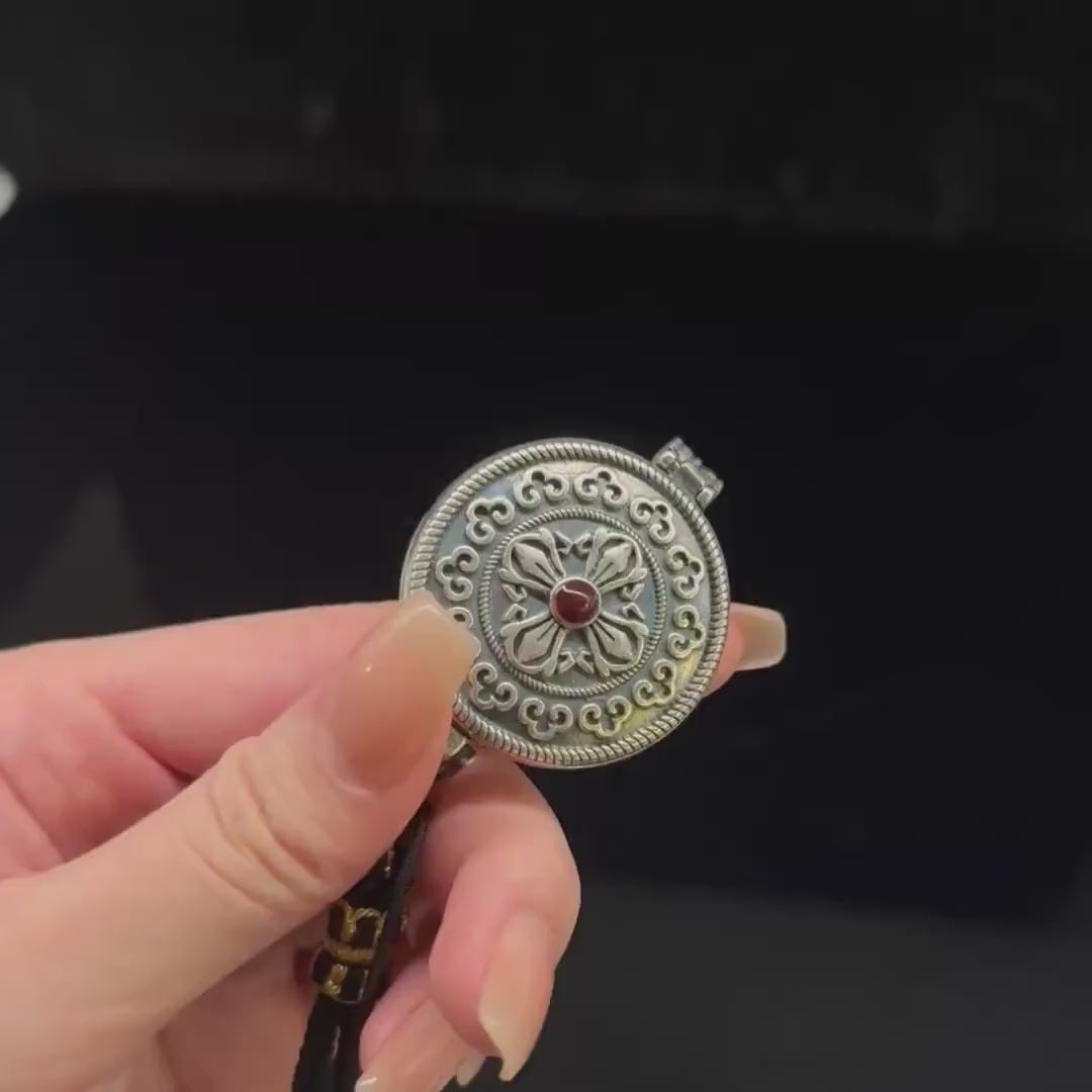 Original Design Eight Auspicious Symbols Kalu Box Pendant, paired with a hand-woven adjustable Perfect Peace necklace.